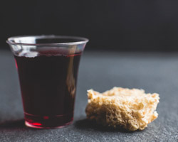 Small communion cup with piece of bread